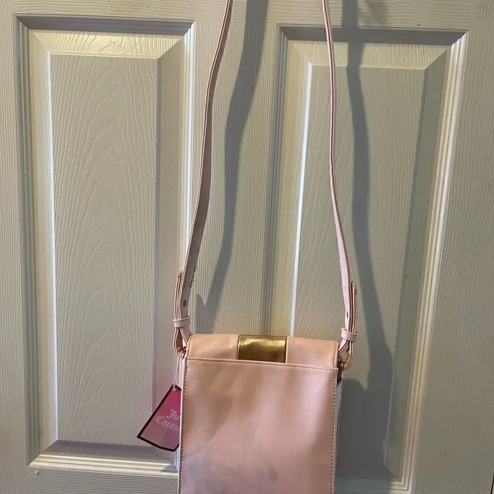 Juicy Couture pink and gold synthetic leather crossbody bag.